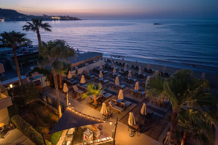 Private beach sunbeds at sunset by the sea, Riviera Restaurant Stalis Crete
